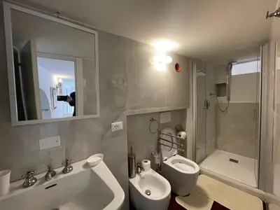 a bathroom with a sink and a toilet and a mirror at Foro Romano Apartments A in Rome