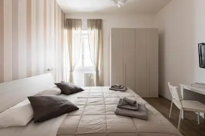 a large bed in a room with a desk at Cornelia House in Rome