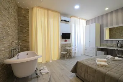 a bathroom with a bed and a bath tub at Vatican Nausicaa in Rome