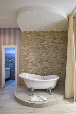 a bath tub in a bathroom with a brick wall at Vatican Nausicaa in Rome