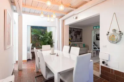 a dining room with a white table and white chairs at Casale 2.0 in Rome