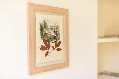 a framed painting of a castle on a wall at Bright and Comfy 3 bedroom apt in Monti in Rome