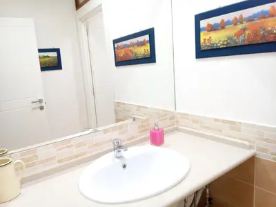 a bathroom with a sink and a mirror at Vetere 101 Apartment in Rome