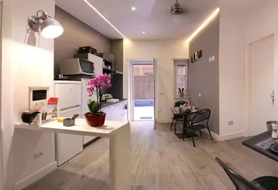 a kitchen and living room with a table and a dining room at Antinori Vatican Suite in Rome