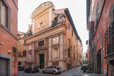 an old building with cars parked on a street at Black White - FromHometoRome in Rome