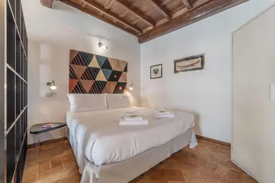 a bedroom with a large white bed in a room at Black White - FromHometoRome in Rome