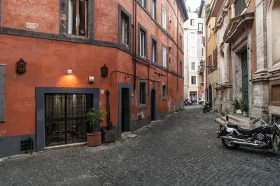 an alley with a motorcycle parked next to a building at Black White - FromHometoRome in Rome