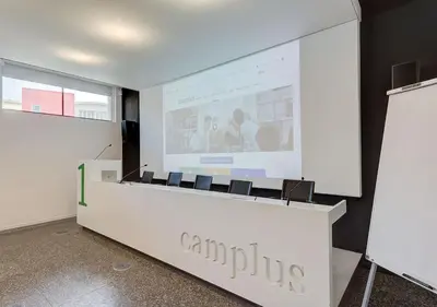 a lecture room with a projection screen and chairs at Camplus Pietralata - Casa per Ferie in Rome