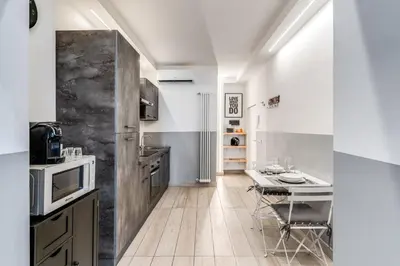 a kitchen with a table and a counter top at Costaguti 36 Apartment in Rome