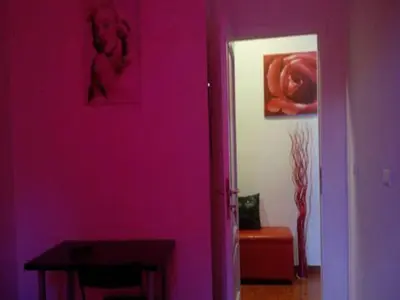 a purple room with a table and a painting on the wall at Magic Stefy's Rooms in Rome