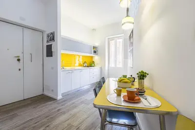 a kitchen with a table and a yellow counter top at Casa Vacanza 