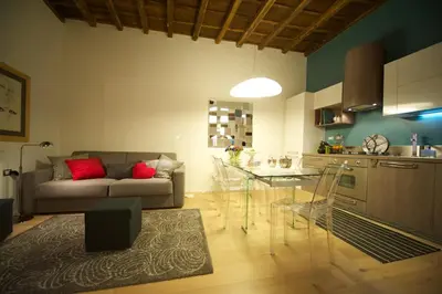 a living room and kitchen with a couch and a table at Fico Blu in Rome