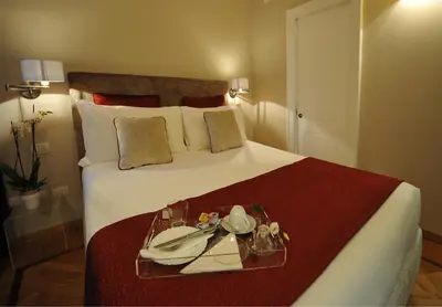 a hotel room with a bed with a tray on it at Angel Spagna Suite in Rome