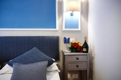 a bedroom with a bed and a window and a nightstand at Domus Cavour Guest house in Rome