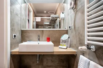 a bathroom with a white sink and a mirror at Hotel Paolo II in Rome