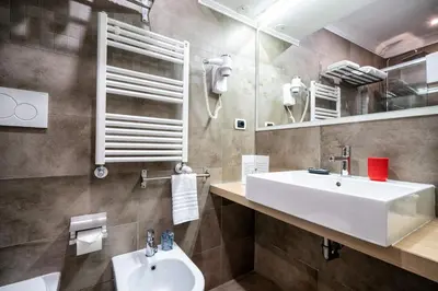 a bathroom with a white sink and a mirror at Hotel Paolo II in Rome