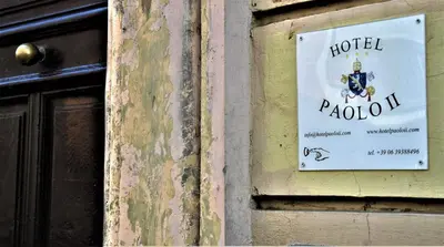 a sign for a hotel on the side of a building at Hotel Paolo II in Rome