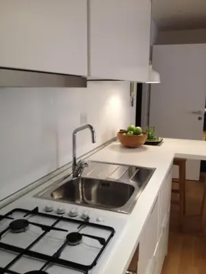a kitchen with a sink and a counter top at White Apartment in San Giovanni in Rome