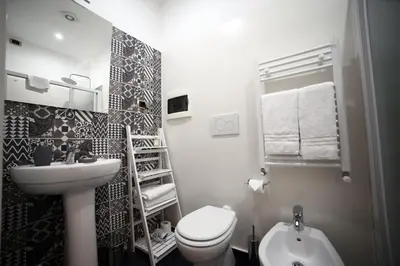 a small bathroom with a toilet and a sink at Dhome B&B in Rome