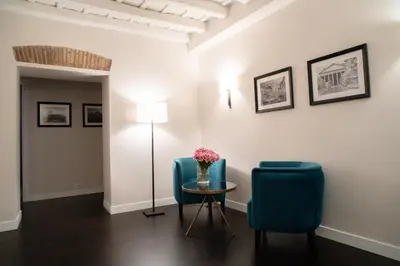 a room with two chairs and a table and a lamp at Kame Hall in Rome