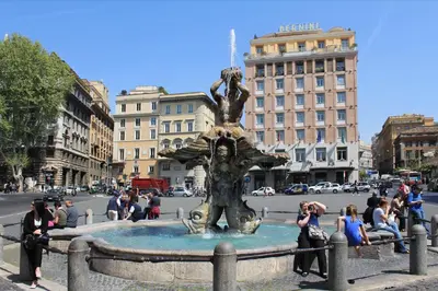 a group of people sitting around a fountain in a city at Rome in your heart - Spagna apartment in Rome