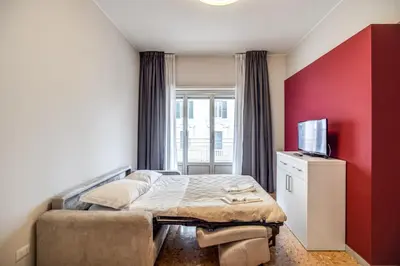 a small bedroom with a bed and a tv at Casa per Ferie Ravasco San Pietro in Rome
