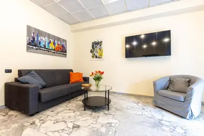 a living room with a couch and a chair and a table at VATICAN Gregory Apartment in Rome