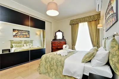 a bedroom with a bed with a stuffed animal on it at Oksana's Bernadette Apartment in Rome