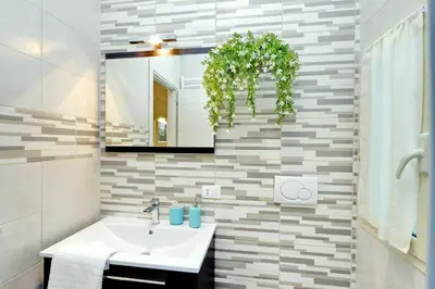 a bathroom with a sink and a mirror at Oksana's Bernadette Apartment in Rome