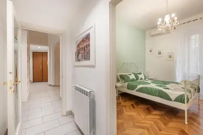 a bedroom with a bed with a green comforter at NOH Family Nest in Rome