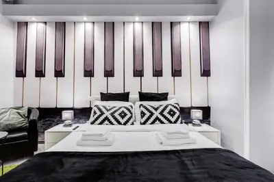 a bedroom with a large white bed with two pillows at Maison Degli Artisti Suites in Rome