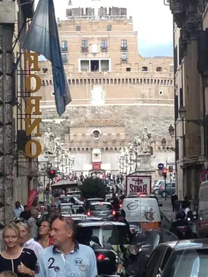 a crowd of people walking down a busy city street at Small Navona Studio in Rome