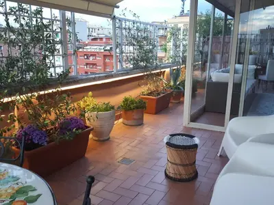 a balcony with a bunch of potted plants on it at Attico Pavia vicino Policlinico in Rome