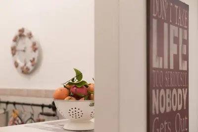 a bowl of fruit on a table with a clock at Simon's place in Rome