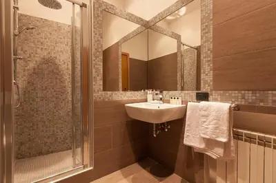 a bathroom with a sink and a shower with a mirror at Prestigious Apartment Piazza Navona in Rome