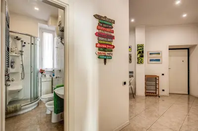 a bathroom with a toilet and a sign on the wall at GreenSugarHome in Rome