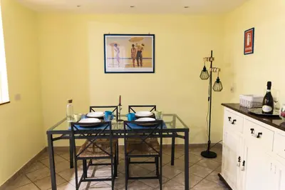 a dining room with a glass table and chairs at TOM'S HOUSE in Rome