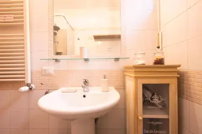 a bathroom with a sink and a mirror at TOM'S HOUSE in Rome
