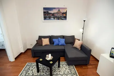 a living room with a couch and a table at Big House Colosseum in Rome