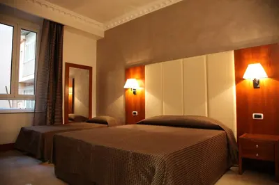 a hotel room with two beds and a window at B&B Federica's House In Rome in Rome