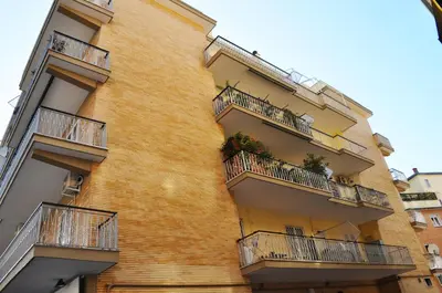 a tall brick building with balconies on it at 
