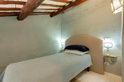 a bedroom with a bed with two lights on the wall at LM Suites Spagna in Rome