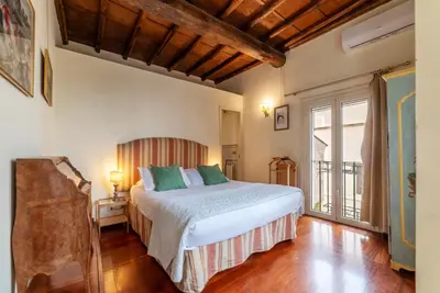 a bedroom with a bed and a large window at Clock Terrace House in Rome