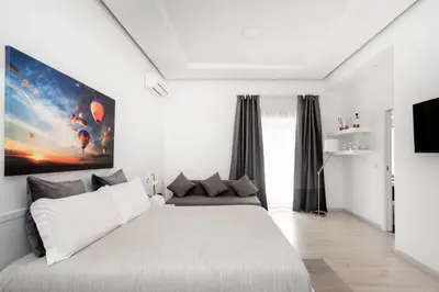 a bedroom with a large white bed in a room at Maison Piazza Cavour in Rome