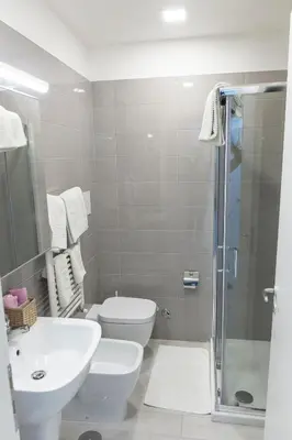 a bathroom with a toilet and a sink and a shower at Metronia Guest House in Rome