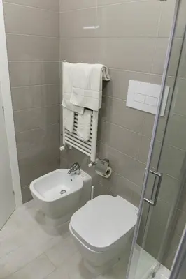 a bathroom with a toilet and a sink and a shower at Metronia Guest House in Rome