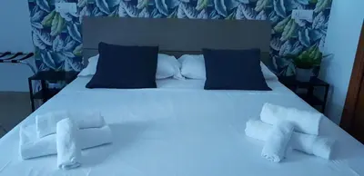 a bedroom with a white bed with blue pillows at Campo de Fiori House in Rome