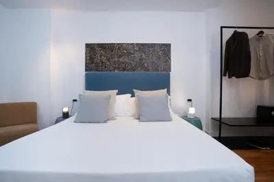 a bedroom with a large bed with white sheets and pillows at PgrHome Riverside in Rome