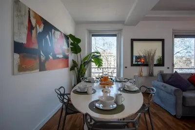 a living room with a table and a couch at PgrHome Riverside in Rome