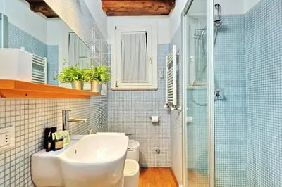 a bathroom with a sink and a toilet and a shower at Parione Charme - My Extra Home in Rome